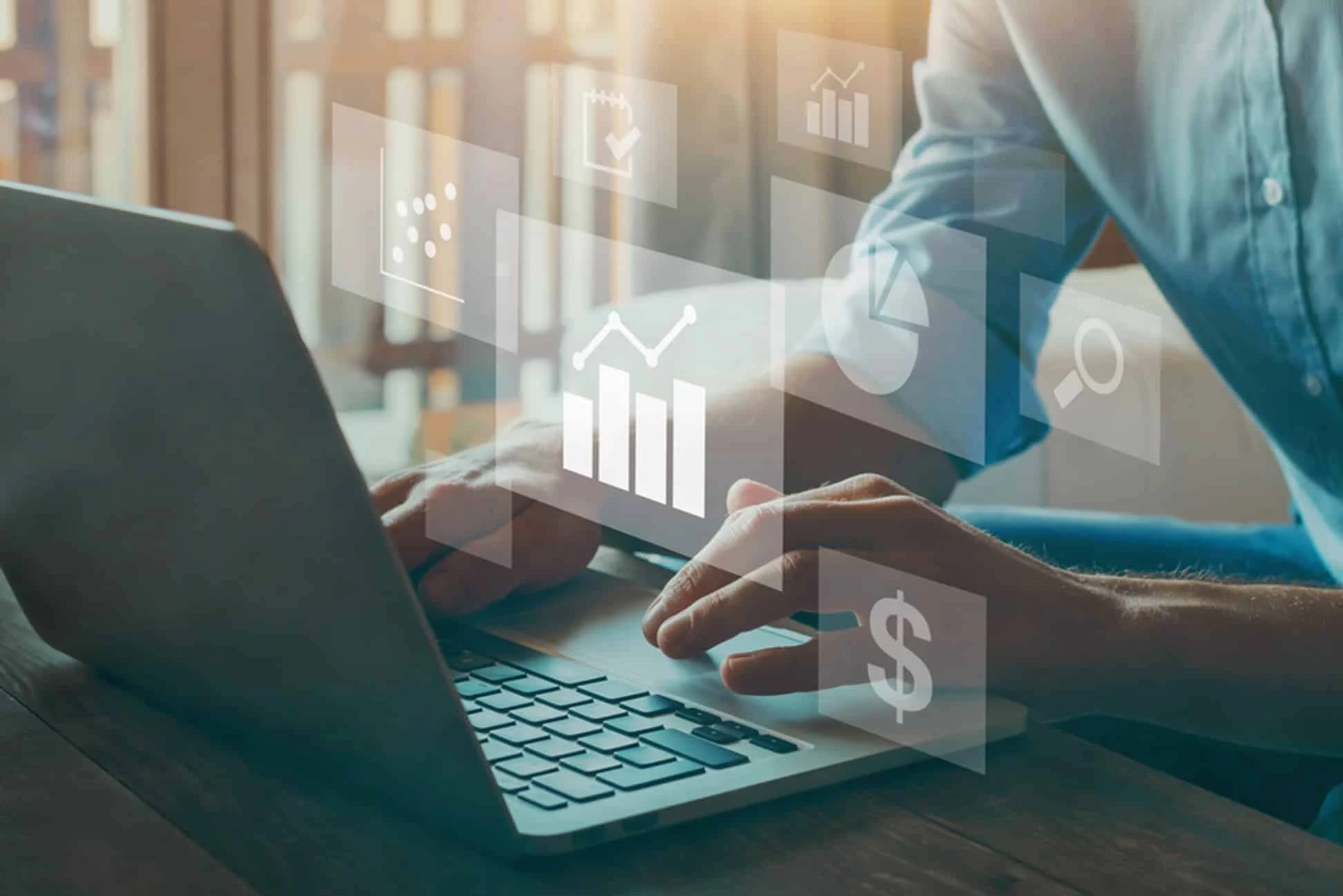 Businessman analyzing data charts and financial metrics on laptop with overlay icons