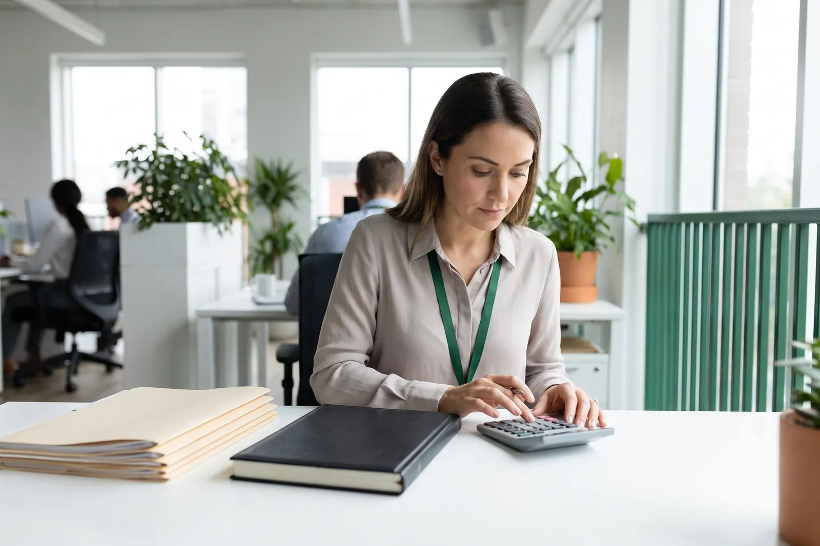 An accountant working with paper ledgers