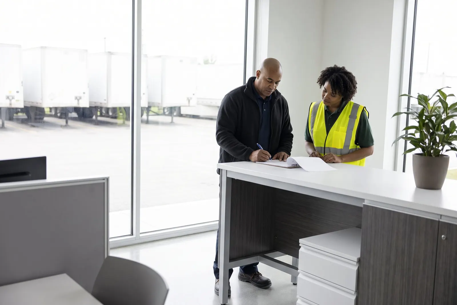 A dispatcher checking paperwork on a clipboard
