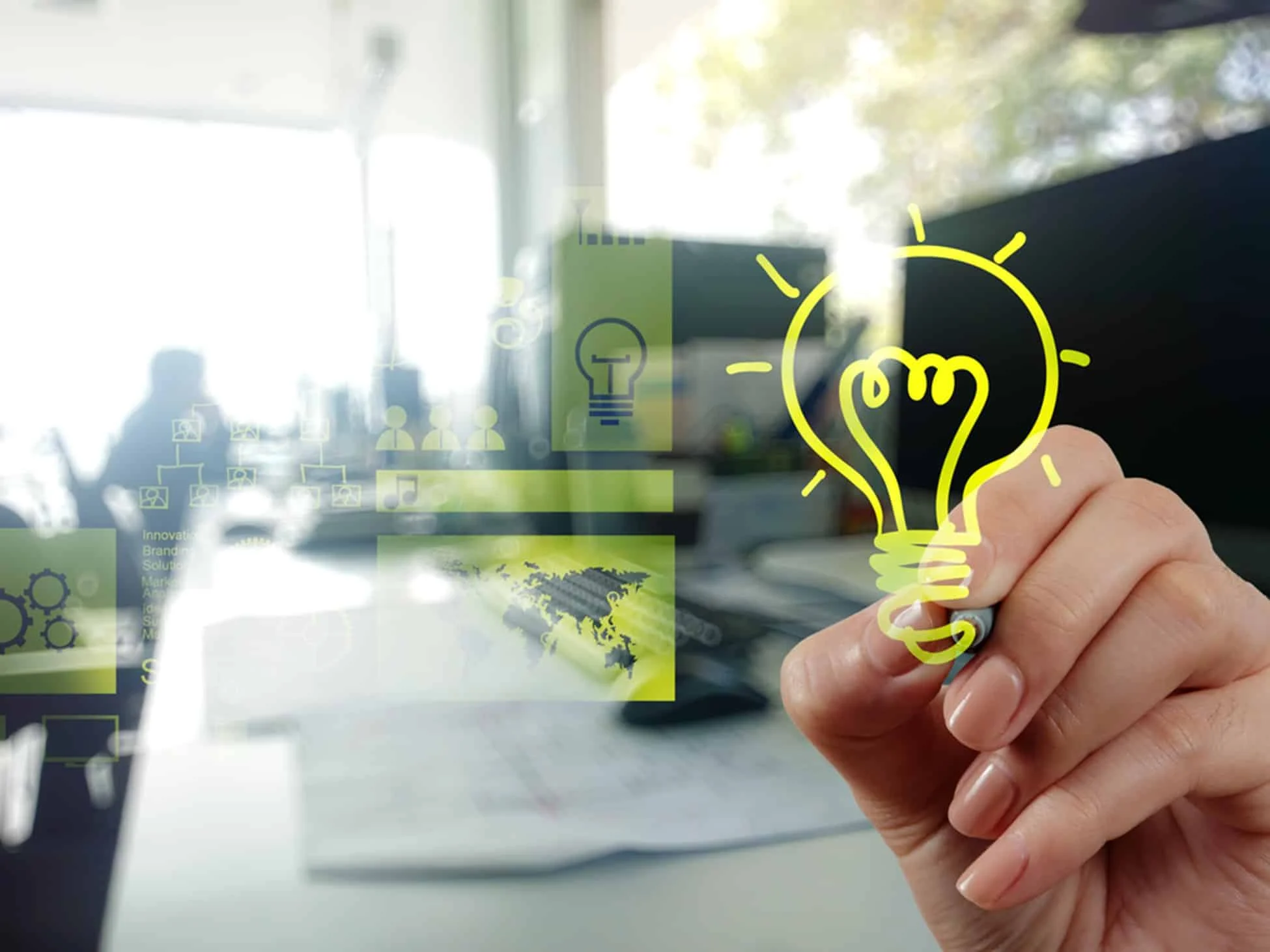 Hand drawing glowing lightbulb icon in modern conference room setting