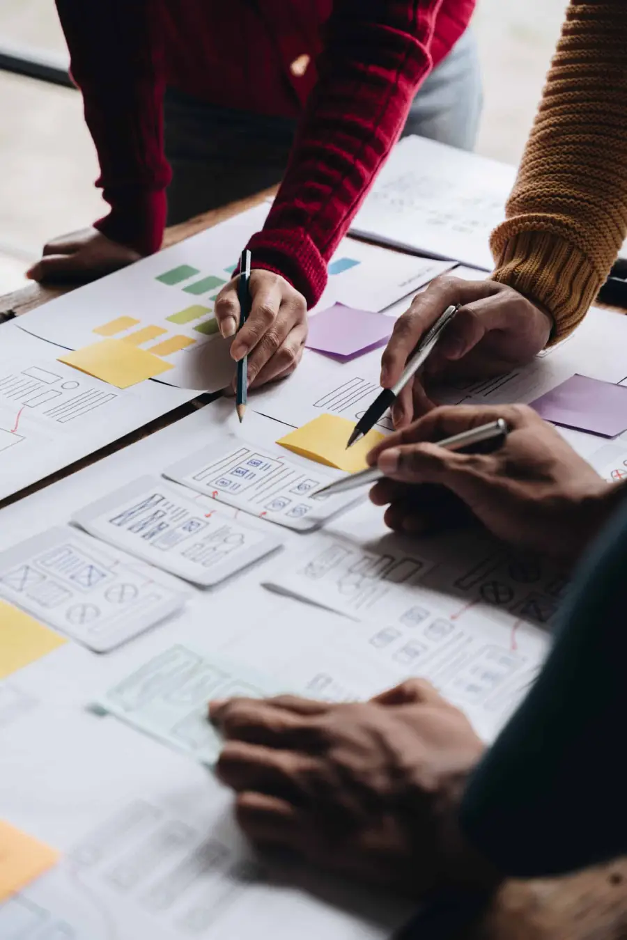 Young business team collaborating with documents and notes on a desk
