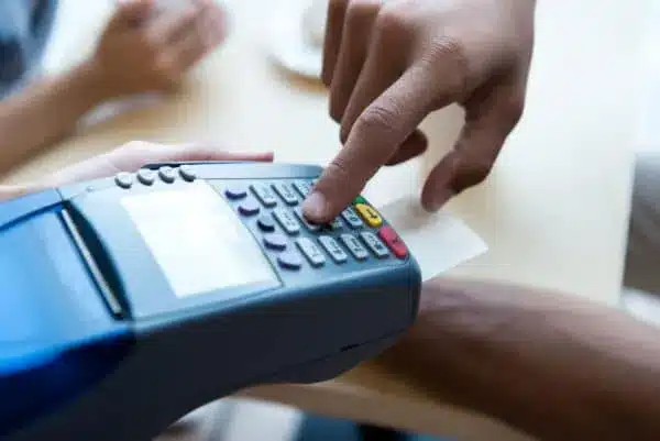 close-up-partial-view-of-person-paying-by-credit-card