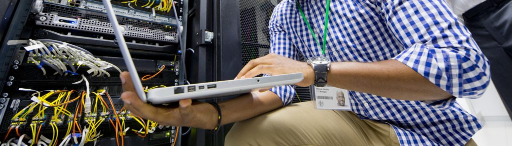 technician with laptop connected to a server