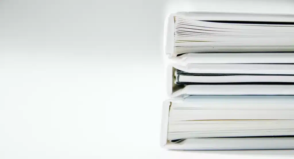 three white binders stacked