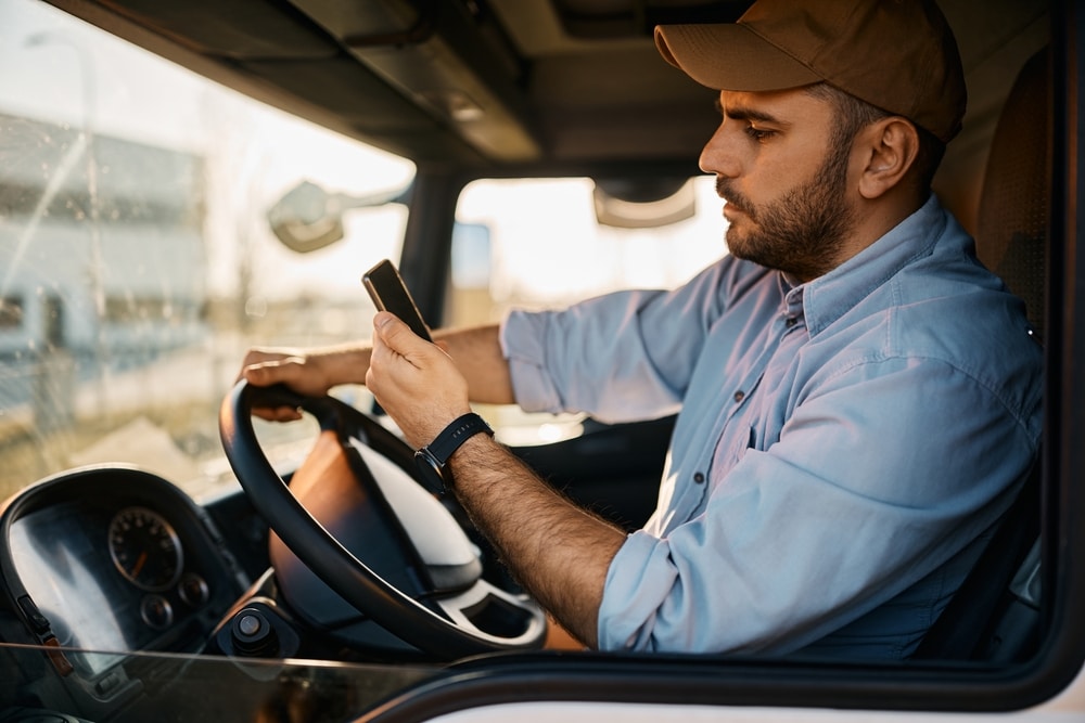 truck driver looking at cell phone