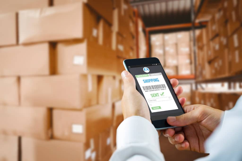 Person managing inventory on smart phone