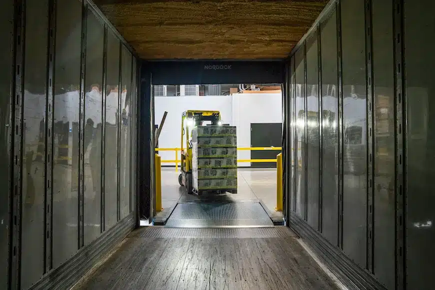 forklift moving a palette of boxes