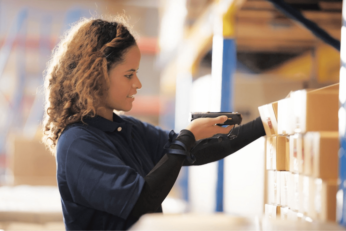 warehouse worker scanning a box with RF scanner