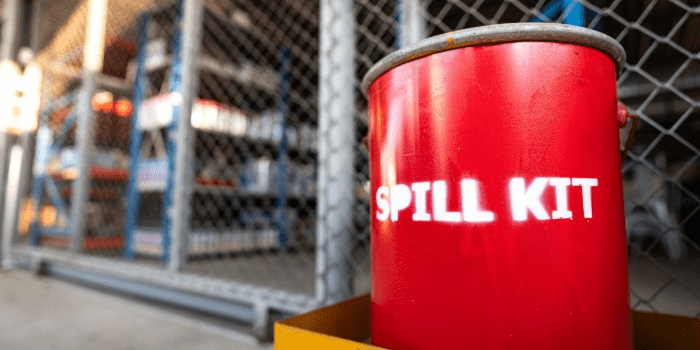 drum labelled spill kit sitting outside a gated area 