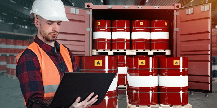 hazardous warehouse unloading a storage container of drums