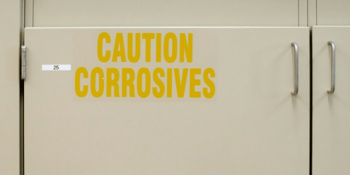 cabinet that says caution corrosives