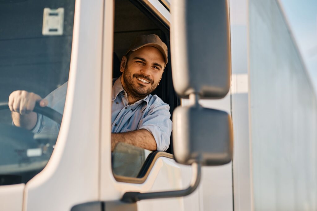 driver looking at the truck window smiling driver looking at the truck window smiling