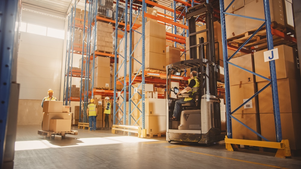 Retail,Delivery,Warehouse,Full,Of,Shelves,With,Goods,In,Cardboard warehouse workers picking items for shipment, forklift in motion