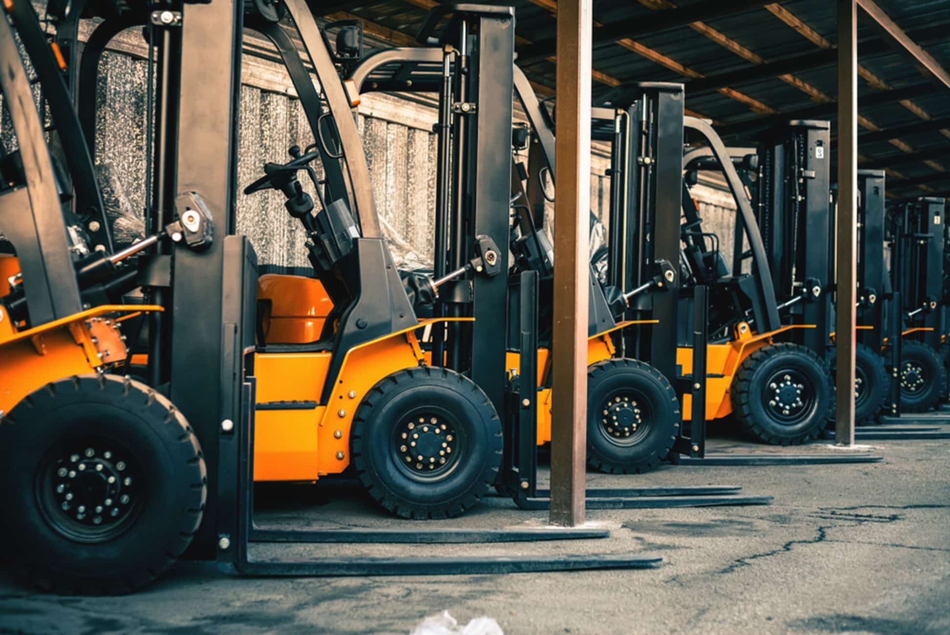 a row of forklifts in a warehouse