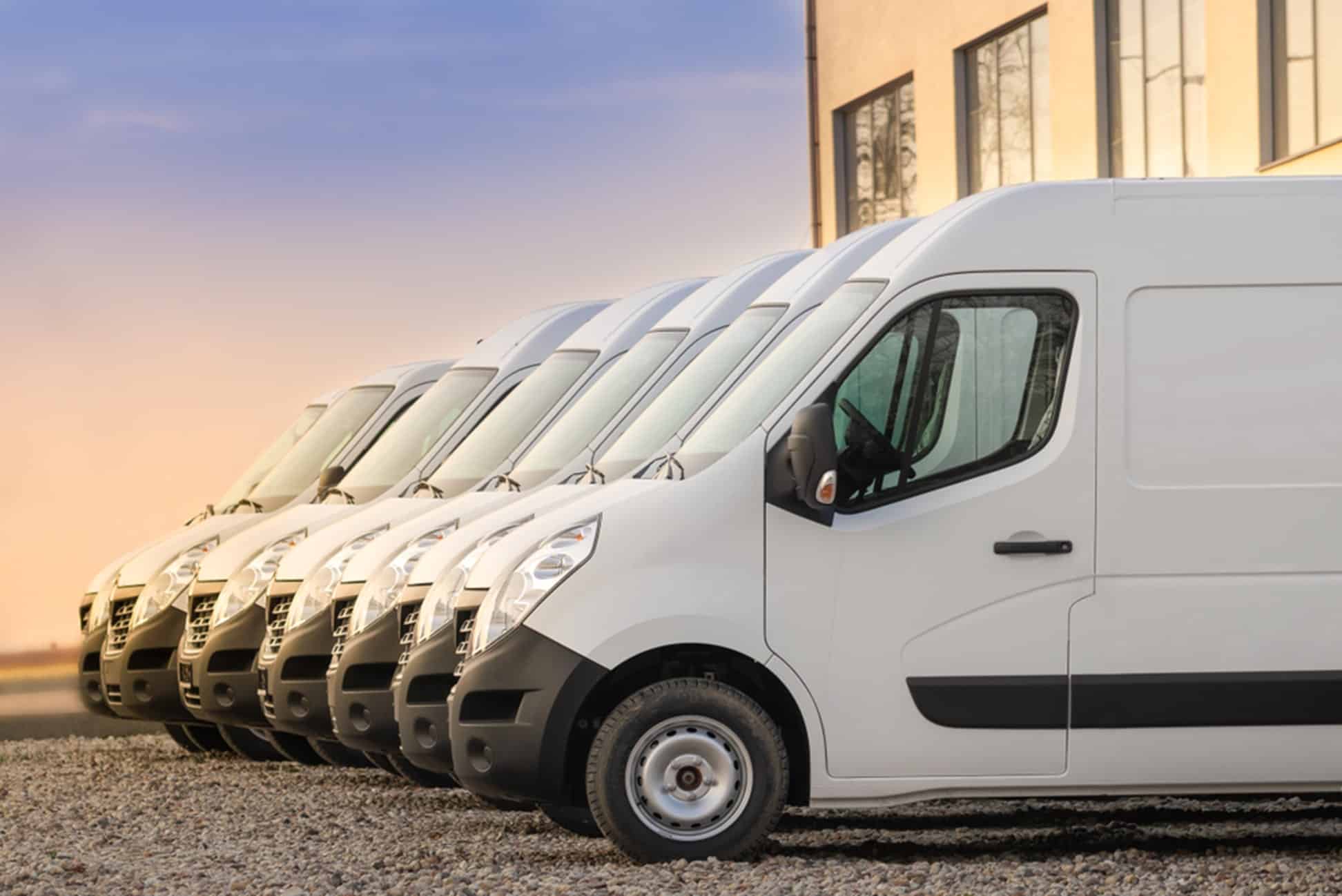 a row of vans outside a distribution center