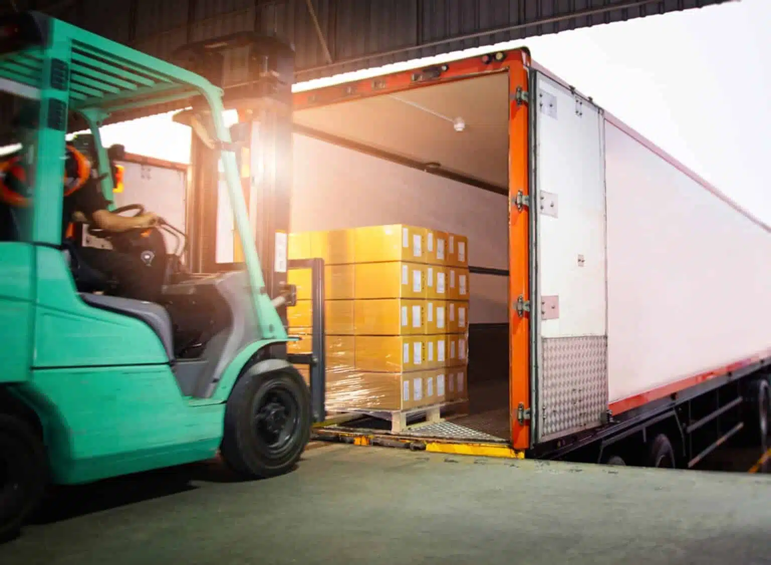 a forklift loading goodes into a truck