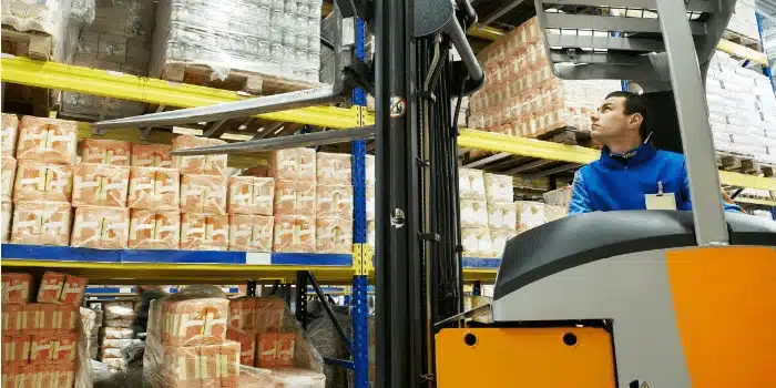 removing stock from a shelf with a forklift