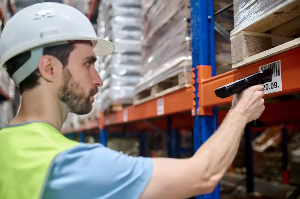 warehouse worker scanning a location label to pick an item