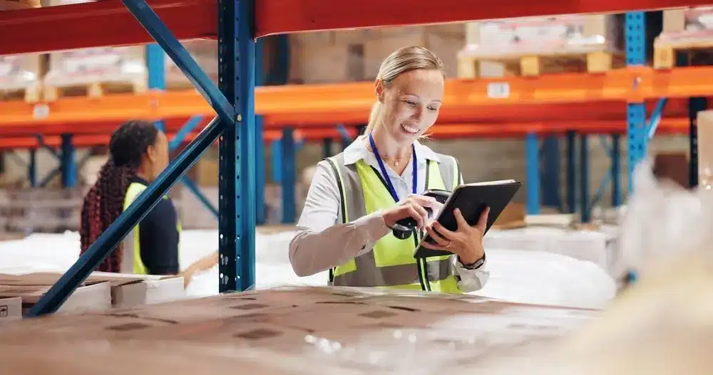 Warehouse manager using tablet to track inventory turnover and stock levels