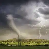 Tornado and lightning storm threatening rural landscape with warehouse security risks